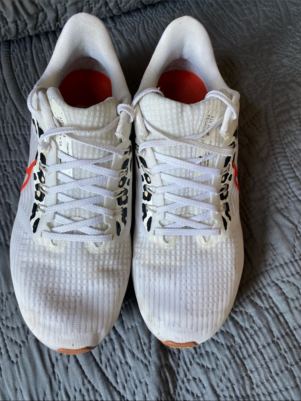 Nike White Running Shoes with Orange Swoosh and Leopard Accents